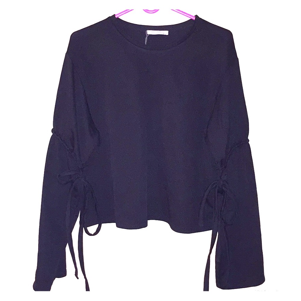 A black long sleeve with a cinch around the arms.